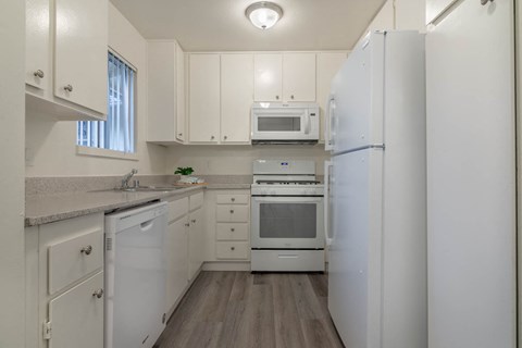 Kitchen with new flooring counters and appliances